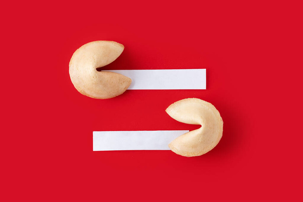 Traditional fortune cookies with white empty paper for text on red background - Fotografie, Obrázek