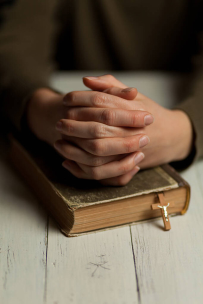 Close-up of praying hands on bible, asking for help from God. - Foto, Imagem