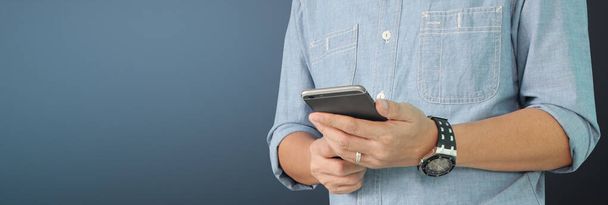 Man holding smartphone device and touching screen - Photo, Image