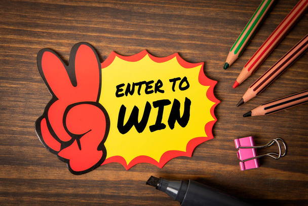 Enter to Win. Text on sticky note, wooden office desk. - Photo, Image