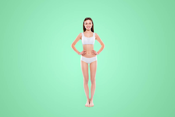 Fullbody portrait of thin slender woman in cotton underwear bikini bra demonstrate ideal body isolated on white background. Enhancement concept. - Photo, Image