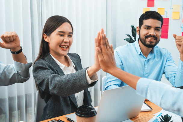 Diverse business team celebrate successful meeting with high-fives and expressions of happiness in corporate office meeting represent unity success and professional integrity. Concord - Foto, imagen
