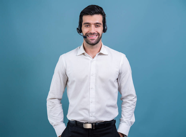 Male call center operator wearing headset and formal suit standing confidently on isolated background portrait. Professional smile and service minded for customer service and support. fervent - Photo, Image