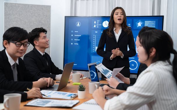 Confidence and young asian businesswoman give presentation on financial business strategy in dashboard report display on screen to colleagues in conference room meeting as harmony in workplace concept - Zdjęcie, obraz