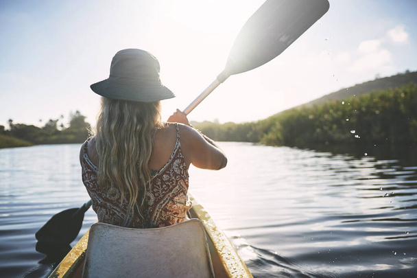 Its peace that Im after. a young woman out kayaking on a lake - Foto, immagini