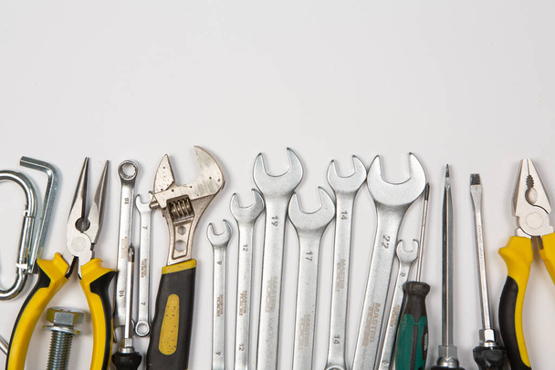 Set of tools for repair in a case on a white background. Assorted work or construction tools. Wrenches, Pliers, screwdriver. Top view - Photo, Image