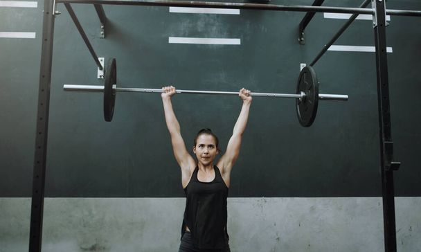 Weightlifting, fitness and woman with barbell in gym for training, exercise and workout for muscles. Sports, deadlift and female body builder lifting weights for challenge, wellness or strength. - Fotoğraf, Görsel