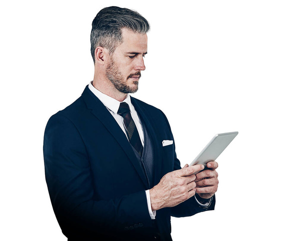His business dealings demand the smartest technology. Studio shot of a businessman using a digital tablet against a white background - Photo, image