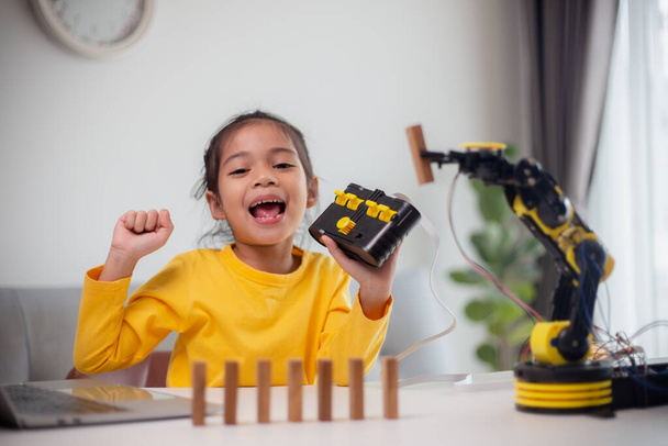 Concept d'éducation aux STIM. Les étudiants asiatiques apprennent à la maison en codant les bras robotisés en STIM, génie mathématique technologie code informatique en robotique pour les concepts des enfants. - Photo, image