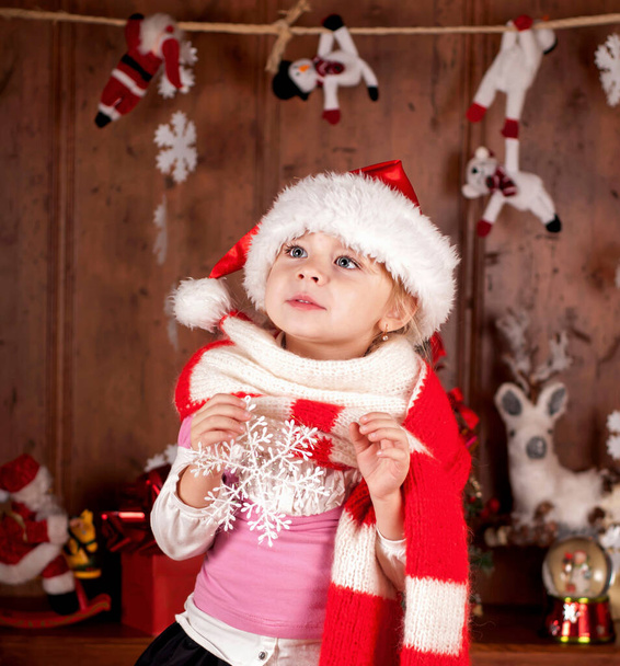 child in a suit of Santa Claus in the room decorated to new year - Photo, image