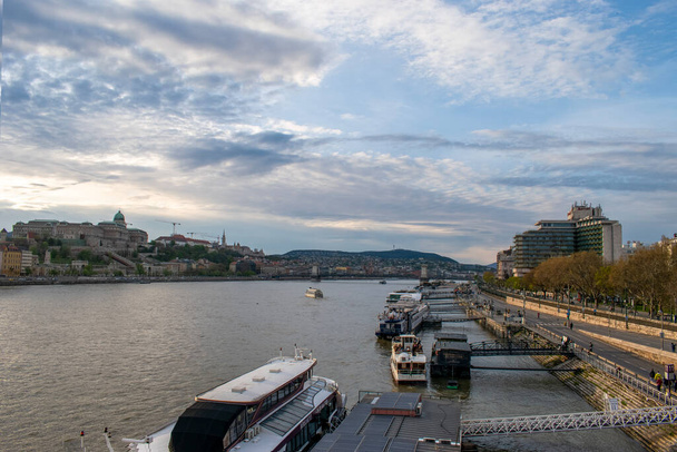 Budapest, Hungary - April 16, 2023 serene beauty a captivating view of the danube river, ships, and tourists in budapest. - Photo, Image