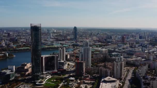 Top view of beautiful city with modern buildings and river. Stock footage. Beautiful city with river and buildings on summer day. River in modern city on background of horizon.  - Footage, Video