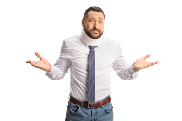 Young injured man with a cervical collar gesturing with hands isolated on white background - Photo, image