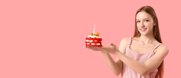 Beautiful young woman with tasty birthday cake on pink background with space for text - Photo, Image