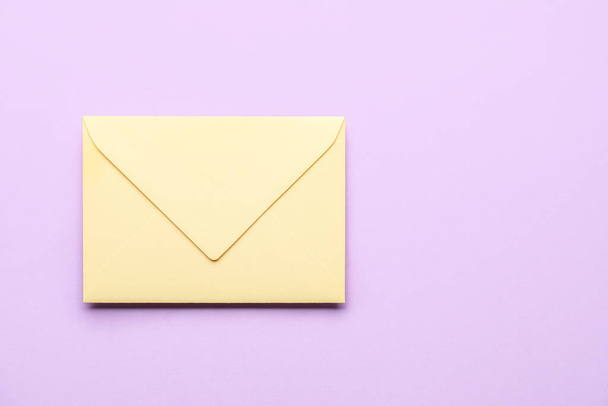 Yellow envelope on lilac background. Message concept - Photo, image