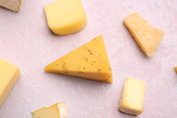 Pieces of tasty cheese on light background - Fotó, kép