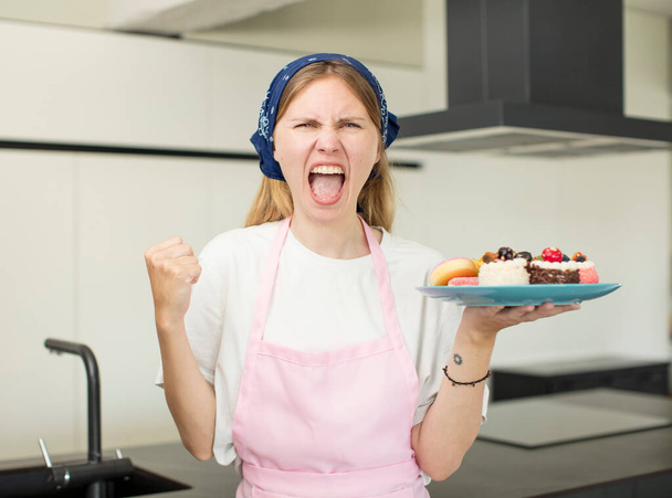 young pretty woman looking angry, annoyed and frustrated. home made cakes concept - Foto, Bild
