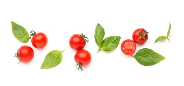Composition with ripe cherry tomatoes and basil leaves on white background - Fotografie, Obrázek