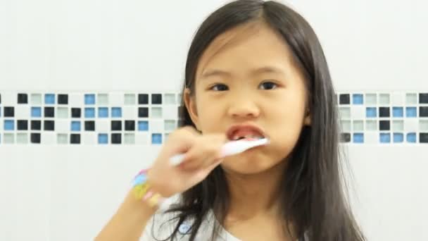 Asian child brushing her teeth - Footage, Video