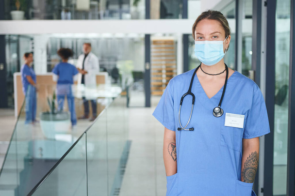 Saving lives is what I was always meant to do. Cropped portrait of an attractive young nurse wearing a face mask and standing in the clinic - Фото, изображение