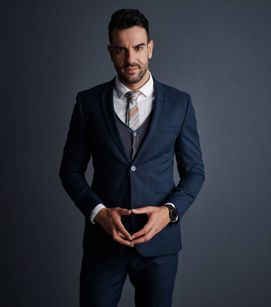 The man on a business mission. Studio shot of a stylish and confident young businessman posing against a gray background - Photo, Image