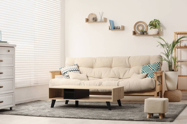 Stylish living room interior with comfortable sofa and side table - Valokuva, kuva
