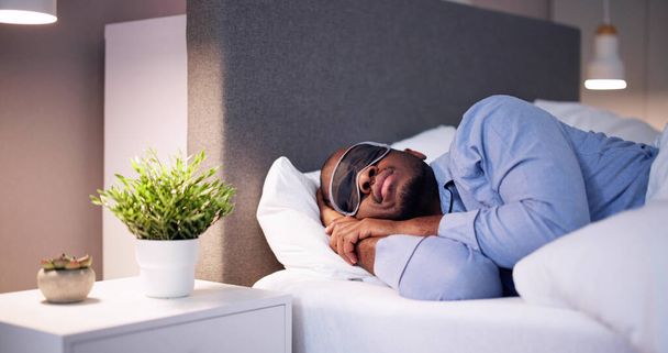 Young African Man Sleeping With Sleep Mask - Foto, afbeelding