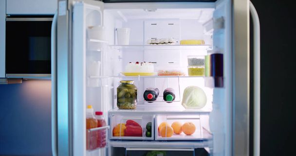 Open Refrigerator Full Of Juice And Fresh Vegetables In Kitchen - Fotografie, Obrázek