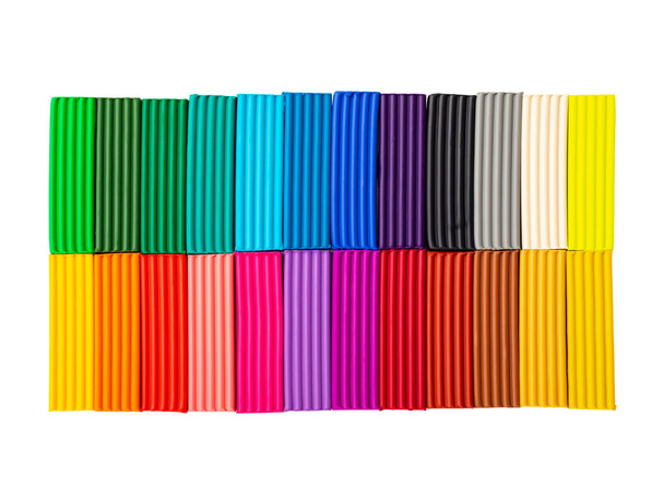 plasticine sticks isolated on white background with clipping path. 24 colors set of colorful modeling clay. Pieces of multicolor plasticine. Top view, close-up. - Foto, immagini