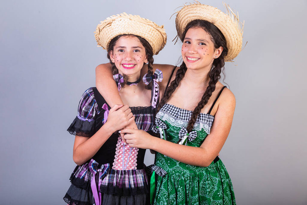 Girls, sisters, friends, Brazilian, with June party clothes, arraial, So Joo party. Horizontal portrait.  - Foto, immagini