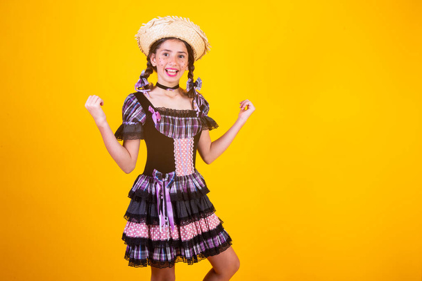 Brazilian girl, with clothes from Festa Junina, Arraial, Festa de So Joao. Horizontal portrait. celebrating, vibrating. - Фото, зображення