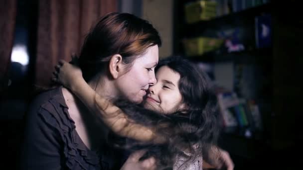 Mom woman with glasses teen daughter  experience tenderness love kissing in the room in the evening - Footage, Video