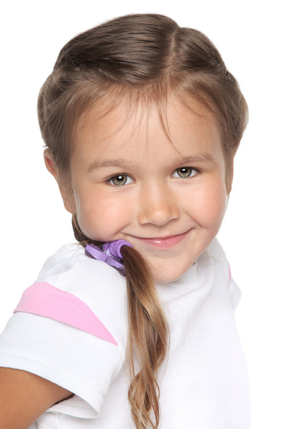 Little school girl. Portrait on white background - Фото, изображение
