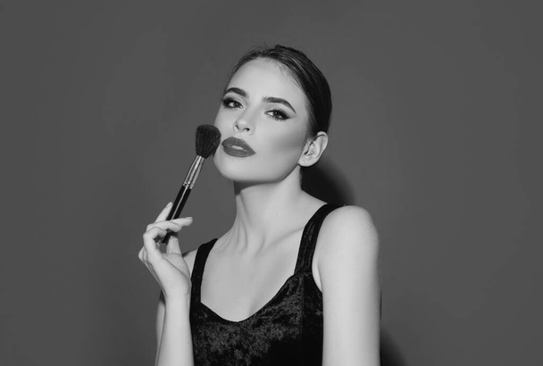 Woman beauty face, portrait of beautiful female model holding makeup brush. Skincare and healthy skin, spa facial treatment concept. Applying tone to skin - Φωτογραφία, εικόνα