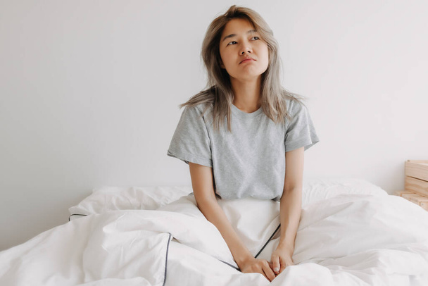 Sleepy and dreaming asian woman just wake up on the bed. - 写真・画像