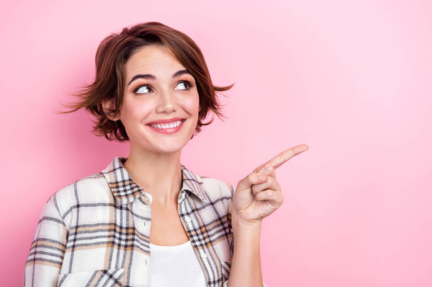 Photo of young business marketer lady brown hair pointing finger empty space enjoy best product price isolated on pink color background. - Fotoğraf, Görsel
