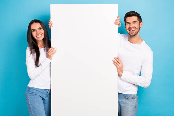 Photo of two cheerful people toothy smile showing empty space blank isolated on blue color background. - Fotoğraf, Görsel