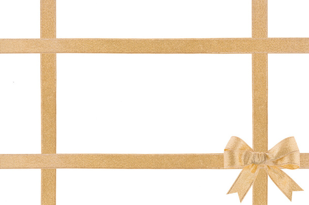Golden ribbon with a bow on white background - Photo, Image