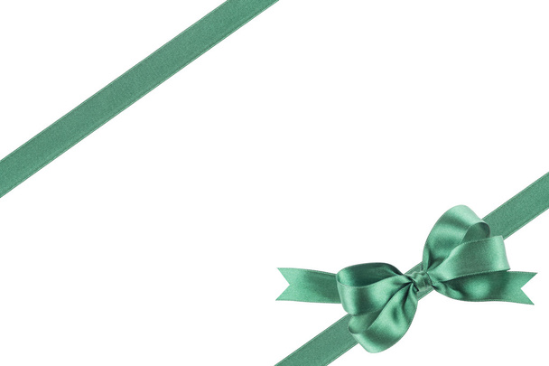 Green ribbon with a bow on white background - Photo, Image