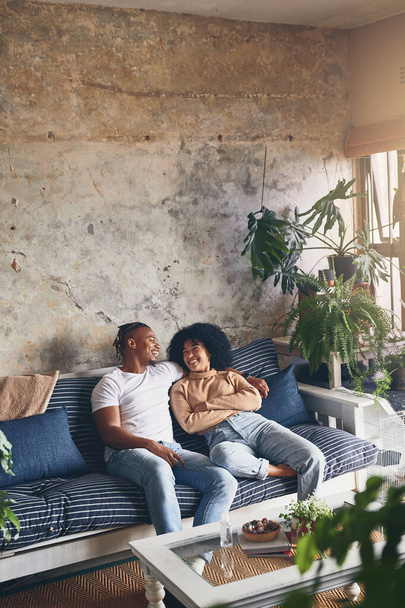 Loving you is both my biggest weakness and greatest strength. a young couple relaxing together on a sofa at home - Foto, Imagem