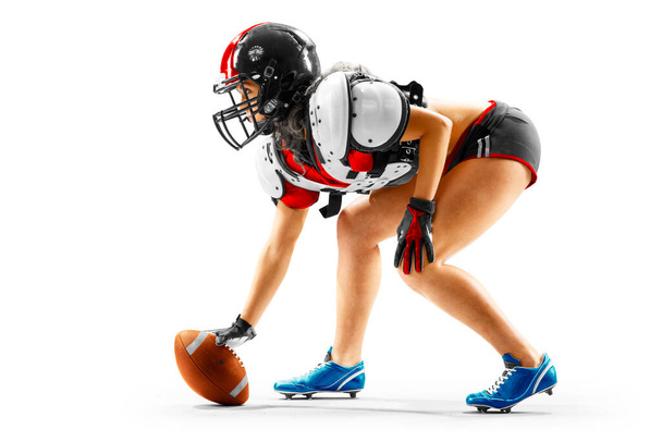 Portrait of attractive brunette female american football player in uniform and jersey T-shirt posing with helmet isolated on the white background - Zdjęcie, obraz