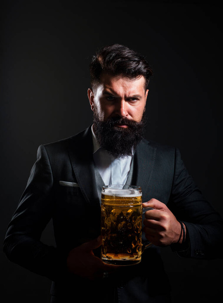 Craft beer. Confident man with bid glass of beer. Degustation and tasting - Fotó, kép
