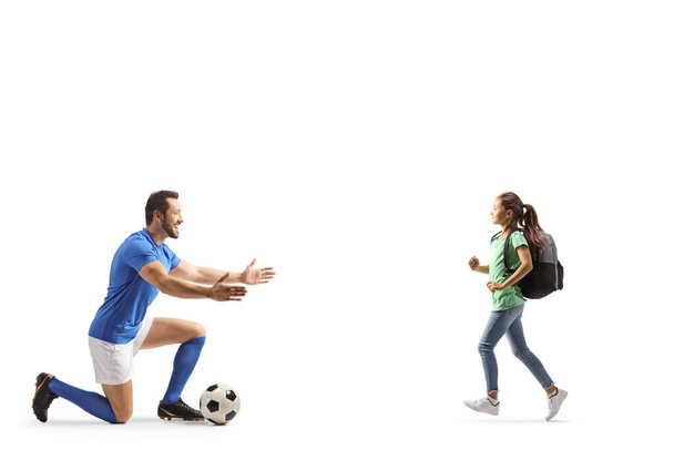 Female pupil running towards a football player isolated on white backgroun - Fotoğraf, Görsel