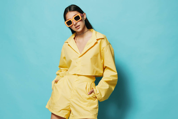 romance woman beautiful trendy summertime dance yellow background joy person female fashion attractive long sunglasses young hair lifestyle emotion hairstyle girl happy - Photo, Image