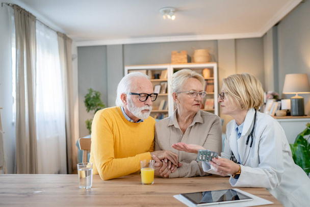 Mature woman doctor visit senior couple man and female husband and wife having a talk and consulting about diagnosis and medical medication treatment real people healthcare concept copy space - Foto, Imagen
