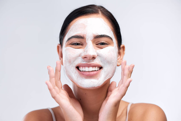 Skincare, face mask and portrait of a woman in a studio for natural, cosmetic and beauty routine. Wellness, health and female model cleaning her skin with facial cleanser isolated by white background. - Φωτογραφία, εικόνα