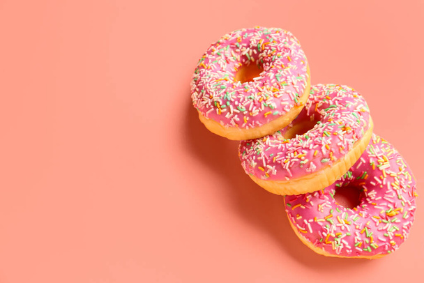 Sweet donuts on pink background - Photo, image