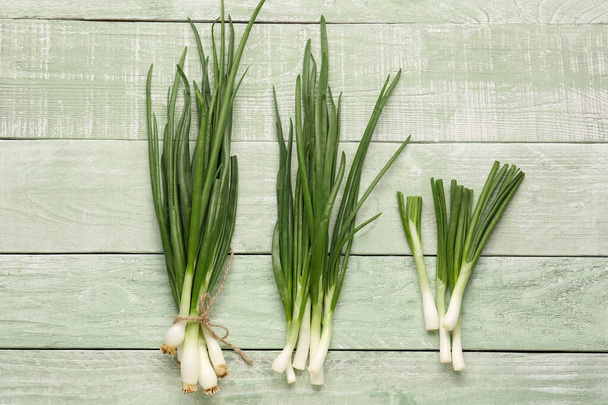 Fresh green onion on wooden background - Photo, image