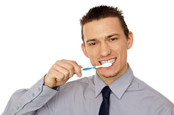 Businessman holding a tooth brush - 写真・画像