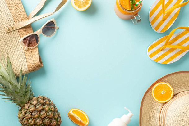 Immerse yourself in the summer spirit with this vibrant arrangement of sunhat, flip-flops, sunglasses, fruit, bag, drinks against a soothing pastel blue backdrop. Empty space for your text or advert - Photo, Image